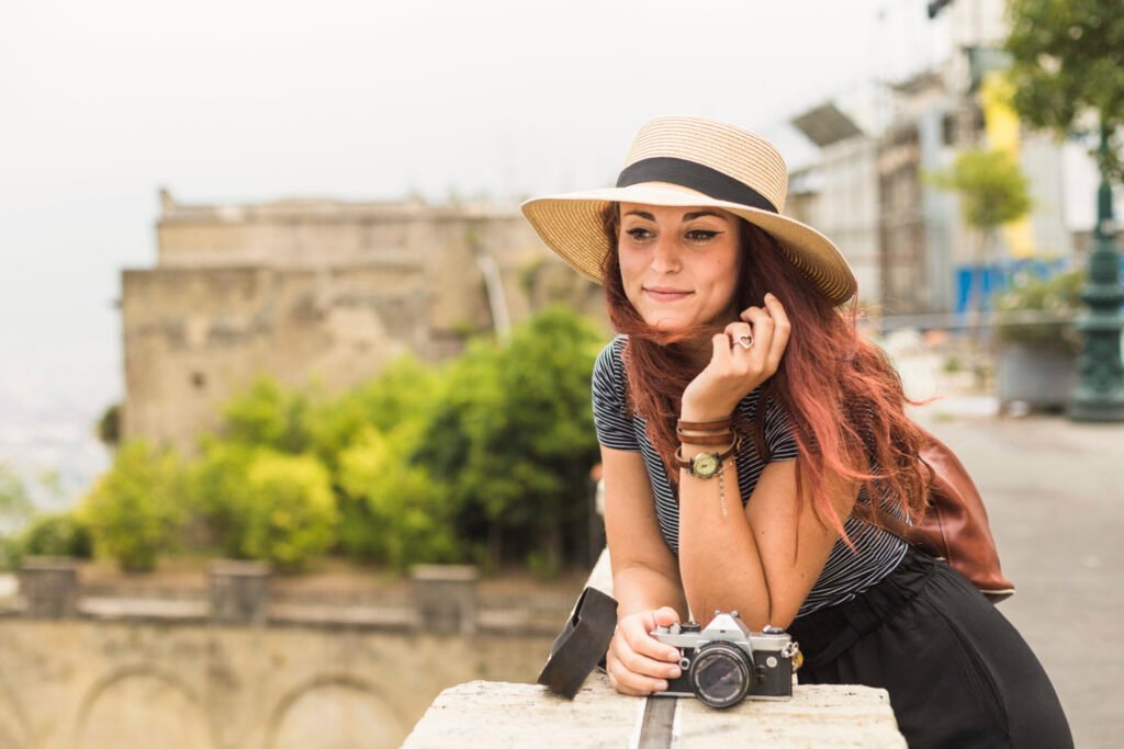 female tourist with camera balcony scaled